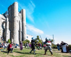 The Brotherhood of the Arrow & Sword perform on the seaside lawn at Hammond Castle Museum. 